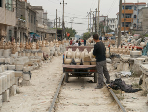 Loading a motorized utility tricycle with slip-cast ware in the Old Factory, Jingdezhen