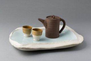 Yixing style teapot with teacups and porcelain tray